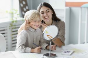 woman-doing-speech-therapy-with-little-boy-her-clinic